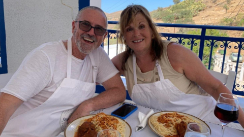A couple is ready to eat the food they have prepared
