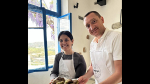 A proud couple showing the tasty food they made 
