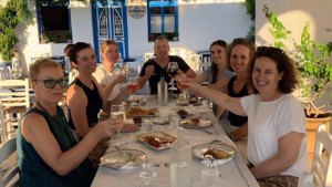 Sit around the table and enjoy the meal you made, with local wine