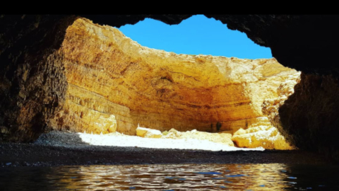 A small beach enclosed by cliffs whispering seclusion