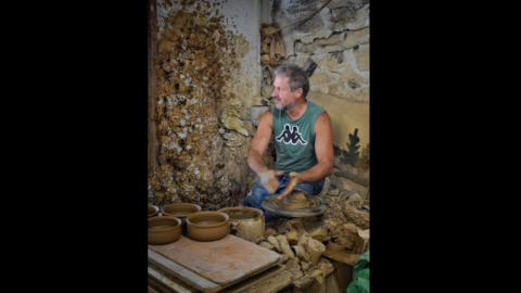 Mister Manolis behind the pottery wheel
