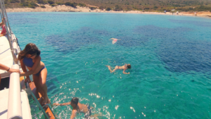 Swim in crystal waters as the afternoon light gently fades
