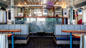 The ship's lounge zone and compact dining area