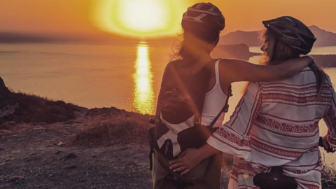 Admire the golden sunset over sparkling volcanic cliffs