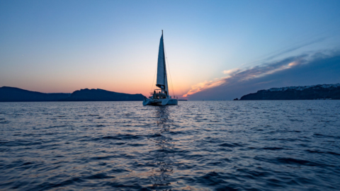 Sail into a breathtaking sunset over crystal waters