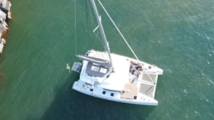 Let the stillness envelop you as the catamaran anchors