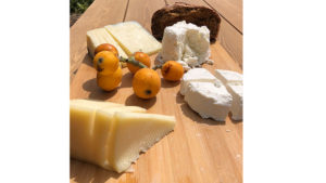The plate is adorned with an assortment of local cheeses