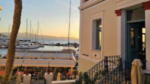 Enjoy the stunning sunset view over the harbor from the neoclassical building in Naxos.