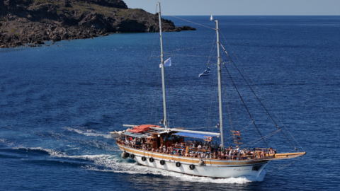 Experience the freedom of the open sea on a wooden boat in Santorini