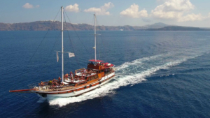 Embark on a timeless journey across Santorini’s waters on a wooden boat