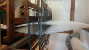 A traditional full size loom in operation