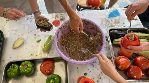 Preparing the mix of rice, herbs and tomato for 'gemista'