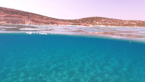 Unwind on pristine sandy beaches framed by vibrant blue waters