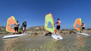 Learn windsurfing in shallow calm waters with steady wind perfect for beginners