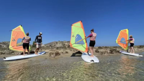Learn windsurfing in shallow calm waters with steady wind perfect for beginners