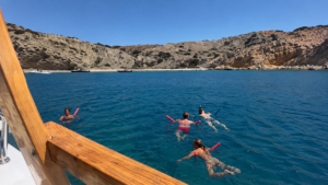 Swimming stop in clear blue waters during the Koufonisia and Rina Cave cruise